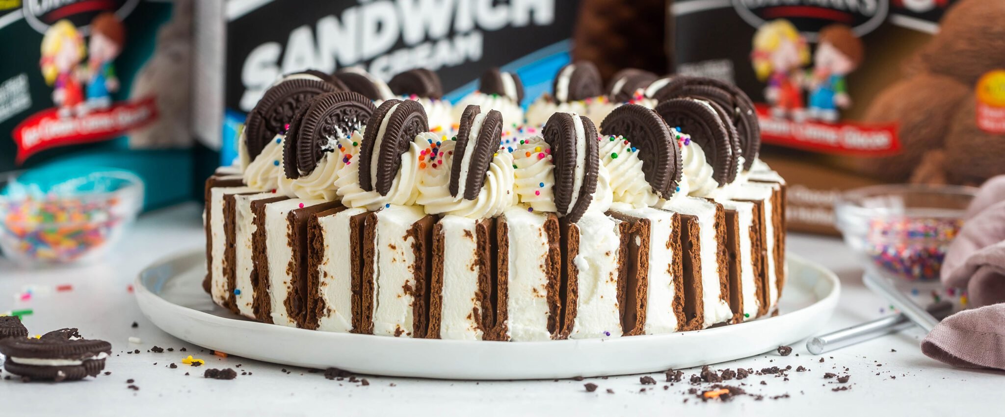 Picture of our ultimate ice cream cake with sandwiches on and cookies on the outside